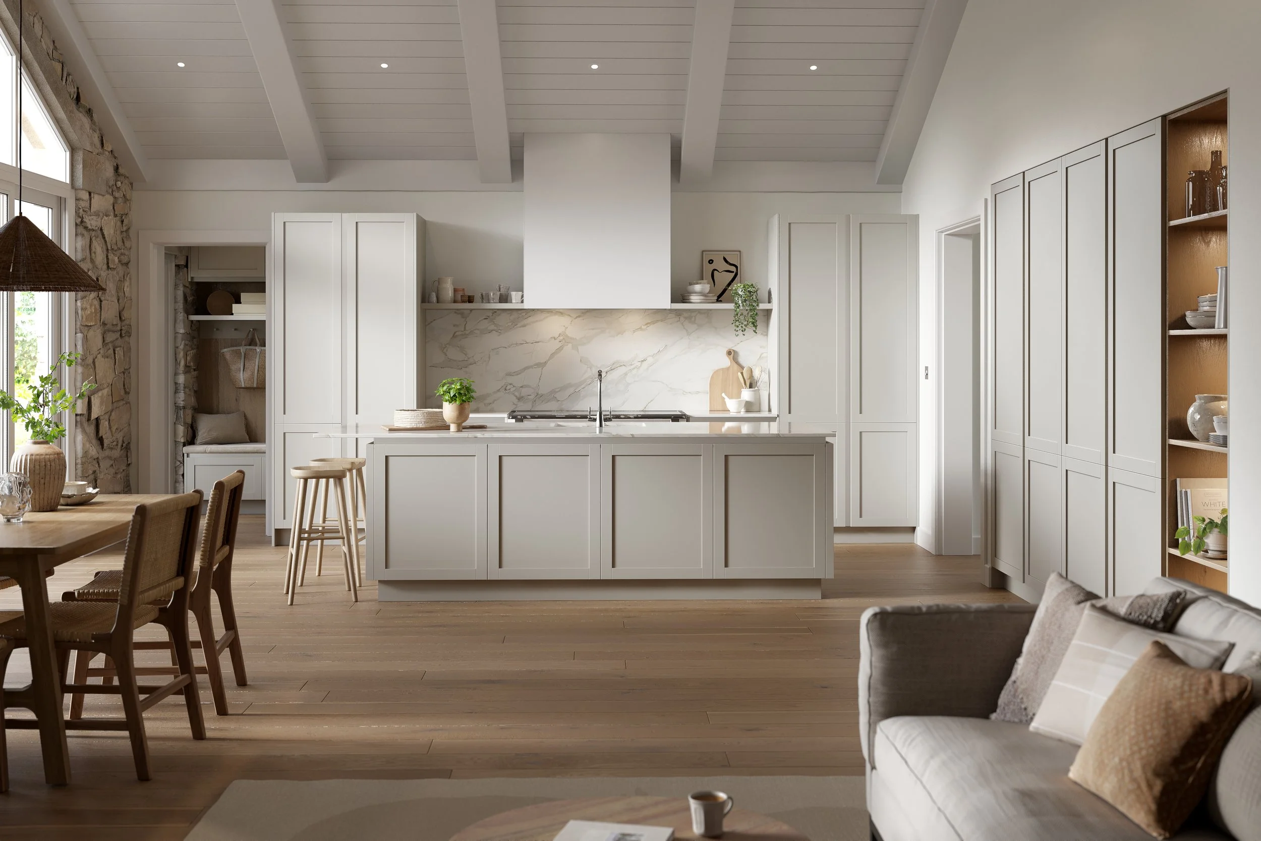 A Novus Monarch shaker kitchen by Omega Plc painted in Sea Mist, photographed in a room with a vaulted timber-beam ceiling, marble-look mantel hood, exposed stone wall and arched pantry, supplied by Oriel Kitchens
